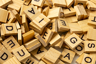 Pile of wooden letter tiles.