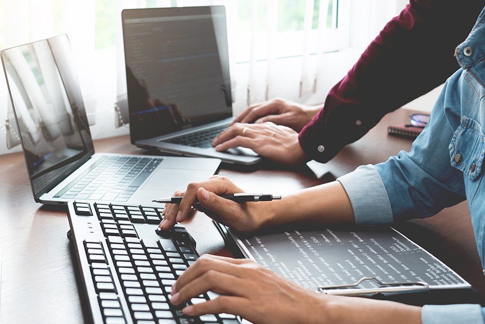 Team of Programmer working to find solution to problem and coding technologies in a software developing company office. SoftwareTech