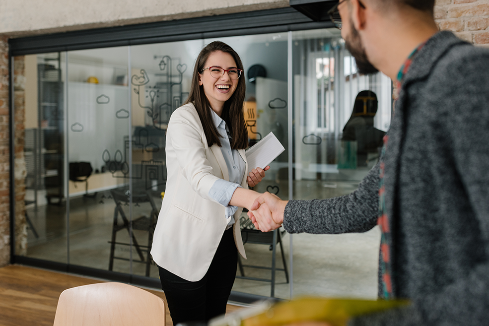 Smiling plainly and firmly handshaking with human resource manager Smiling plainly and firmly handshaking with human resource manager
